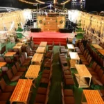 Princesa Dinner Cruise Goa seating arrangement with decorated lights and stage setup for evening entertainment.